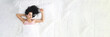 © H_Ko - Beautiful woman sleeping serenely in bed top view. Sound healthy sleep and comfort concept