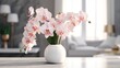 rose and white orchids in a glass vase on white table, blurry living room background with copy space