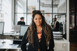 © Maskot - Portrait of mature businesswoman with dreadlocks at office