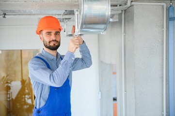 Wall Mural - hvac engineer install heat recovery ventilation system for new house. copy space