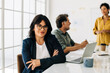 © (JLco) Julia Amaral - Professional woman sitting in a boardroom with her colleagues