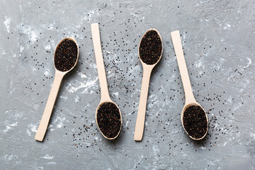 quinoa seeds in bowl and spoon on colored background. Healthy kinwa in small bowl. Healthy superfood