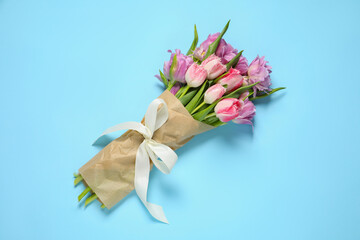 Wall Mural - Beautiful bouquet of colorful tulip flowers on light blue background, top view