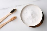 Fototapeta Sypialnia - Bamboo toothbrushes and bowl of baking soda on white marble table, flat lay