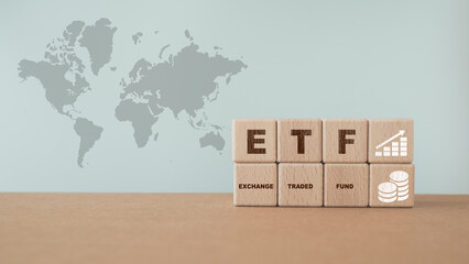 wooden cube with ETF text , Exchange Traded Fund, increasing graph and icon icon on world map background including copy space. For business finance conceptual