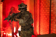 Army Elite Troops Marksman, Special Operations Forces Sniper Wearing Mask And Glasses, Night-vision Or Infrared Thermal Imaging Device On Helmet, Holding Service Rifle With Optical Sight And Silencer
