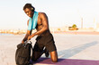 © JustLife - Fitness training outdoors. Handsome African man preparing for the training.