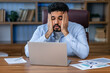 © Ivan - Stressful Job. Stressed Arab Businessman At Laptop Touching Head Having Problem At Workplace Sitting In Modern Office. Crisis And Entrepreneurship Business Issues, Headache Concept