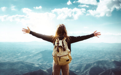 Wall Mural - Woman with backpack raising arms up on the top of the mountain - Successful hiker enjoying freedom on scenic nature panorama - Extreme sport life style concept
