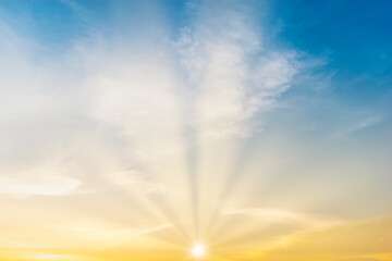 Wall Mural - Sky blue and orange light of the sun through the clouds in the sky