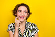 Portrait of good mood woman with short hairstyle wear striped blouse look empty space finger lip isolated on yellow color background