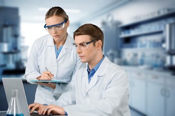 Wall Mural - Two smart scientists using computer in medical laboratory