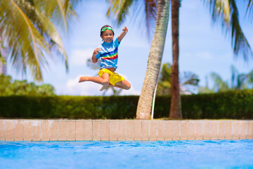 Wall Mural - Kids jump into swimming pool. Summer water fun.