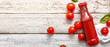 © Pixel-Shot - Bottle of ketchup and tomatoes on light wooden background with space for text