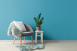 © Pixel-Shot - Cozy armchair with cushion, fur rug and houseplant on stool near blue wall