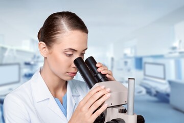 Poster - Young smart scientist with a microscope in the laboratory.