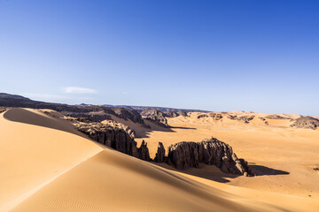 Wall Mural - view in the Sahara desert of Tadrart rouge tassili najer in Djanet City  ,Algeria.colorful orange sand, rocky mountains