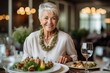 © Leon Waltz - Portrait of smiling senior woman sitting at restaurant table with appetizer