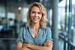 © Robert MEYNER - Portrait of beautiful young businesswoman smiling at camera while standing in office