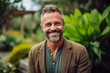 © Eber Braun - Medium shot portrait photography of a grinning man in his 40s that is wearing a chic cardigan against a garden or botanical background .  Generative AI