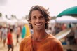 © Leon Waltz - Portrait of a smiling young man with surfboard on the beach