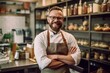 © Leon Waltz - Handsome young man in apron is looking at camera and smiling while standing in the bakery