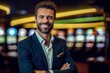 © Leon Waltz - Portrait of handsome businessman standing with arms crossed in casino at night