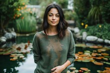 Medium Shot Portrait Photography Of A Satisfied Woman In Her 30s That Is Wearing A Cozy Sweater Against A Tranquil Koi Pond With Fish And Water Lilies Background .  Generative AI