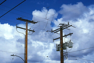 Wall Mural - Electricity pylons under heavy cumulus clouds