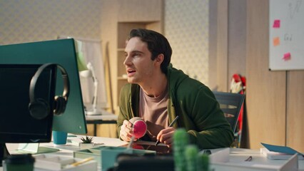 Wall Mural - Relaxed guy looking computer screen at office. Talented artist drawing tablet