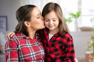 Canvas Print - Happy child hugs young mother