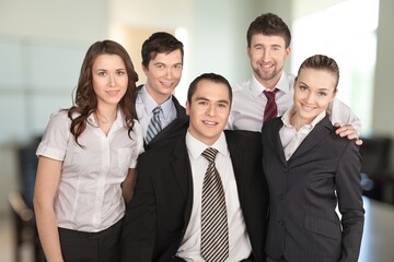 Wall Mural - Group of smart young businesspeople in an office.