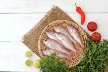 Wall Mural - Fish caught in the sea, white wooden table, background