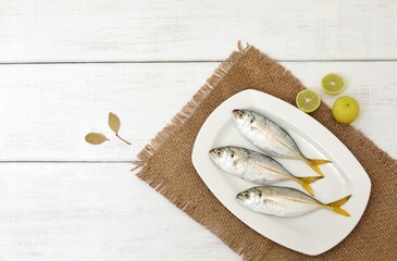 Wall Mural - Atule mate,fresh mediterranean fish, on a white table, Yellowtail Scad,background image, background