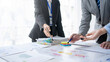 © amnaj - Business people meeting explaining the financial graph data and marketing plan. Group of business people at meeting assessment the state of business investment and marketing.