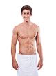 © Adv RT Team Feb/peopleimages.com - Body muscle, portrait and man in towel standing isolated on a transparent png background. Cleaning, skincare or smile of fitness model with strong abs after exercise, workout or training for wellness