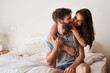 © Emil Lime/peopleimages.com - Love, apartment bedroom and happy couple hug, bond and spending relax morning together, bonding and smile. Happiness, home or romantic people embracing with affection, care and quality time on bed