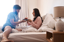 Happy Couple, Bedroom And Birthday Muffin, Morning Dessert Or Celebration Food For Excited Woman. Cupcake Candle, Surprise Sweets And Fun People Smile, Happiness And Celebrate Special Day On Home Bed