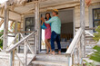 © wavebreak3 - Happy caucasian senior couple wife dancing cheerfully on balcony outside wooden cottage
