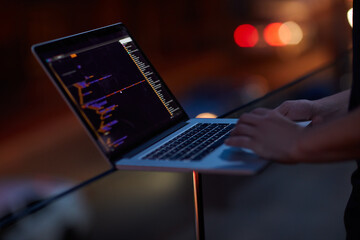 Hacker, code and laptop with hands of person for ransomware, cyber security and phishing. Coding, technology and crime with closeup of programmer for fraud, network system and data scam at night