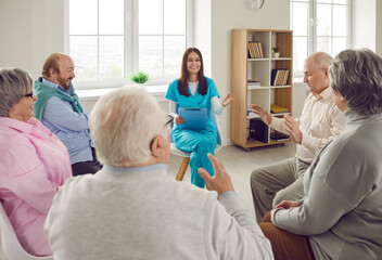 Group of happy senior people, old male female retirement home patients and young nurse carer specialist counselor caretaker worker girl with clipboard meet, have conversations, laugh at funny jokes