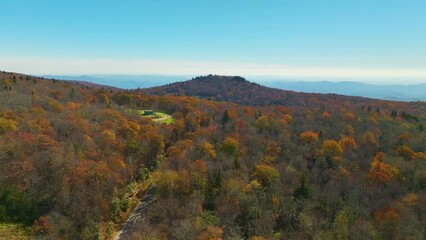 Wall Mural - Aerial view of Appalachian mountain hills with brightly illuminated lush and pine woods at fall season. Autumnal landscape of beautiful nature