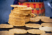 Handmade Corn Tortillas On A Metal Plate Called "Comal" In Guatemala City, Indigenous Woman And Mayan Culture In Central America.