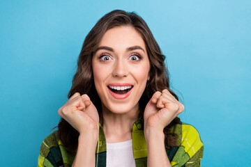 Sticker - Photo of lucky cheerful lady wear checkered jacket open mouth rising fists isolated blue color background