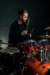 © Guys Who Shoot - a young male drummer plays a drum kit in a recording studio at a professional musician's rehearsal recording a song