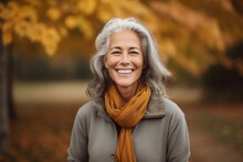 Medium Shot Portrait Photography Of A Glad Mature Woman Smiling Against An Autumn Foliage Background. With Generative AI Technology