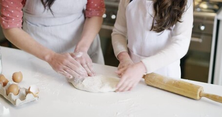 Wall Mural - Mother baking with pastry with her child in the kitchen for a party, celebration or handmade dessert. Home, weekend and closeup of woman rolling dough with her girl kid to bake sweet treats together.