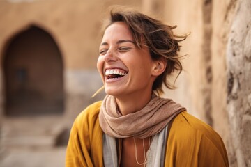 Wall Mural - Close-up portrait photography of a grinning girl in her 30s laughing against a peaceful monastery background. With generative AI technology