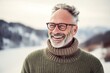 Photography in the style of pensive portraiture of a happy mature man wearing a cozy sweater against a snowy landscape background. With generative AI technology