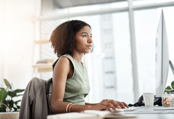 Reading, computer and business woman in office for website management, copywriting or editing online software. Young african person, writer or editor with web article, research and blog on desktop pc